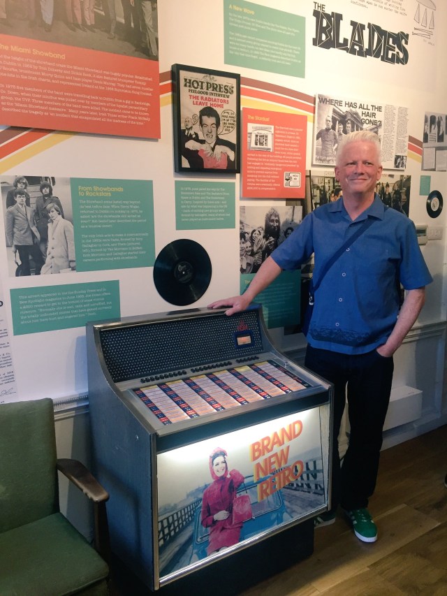 Brian McMahon, Brand New Retro, curator of the exhibition, at the fully functioning vinyl jukebox